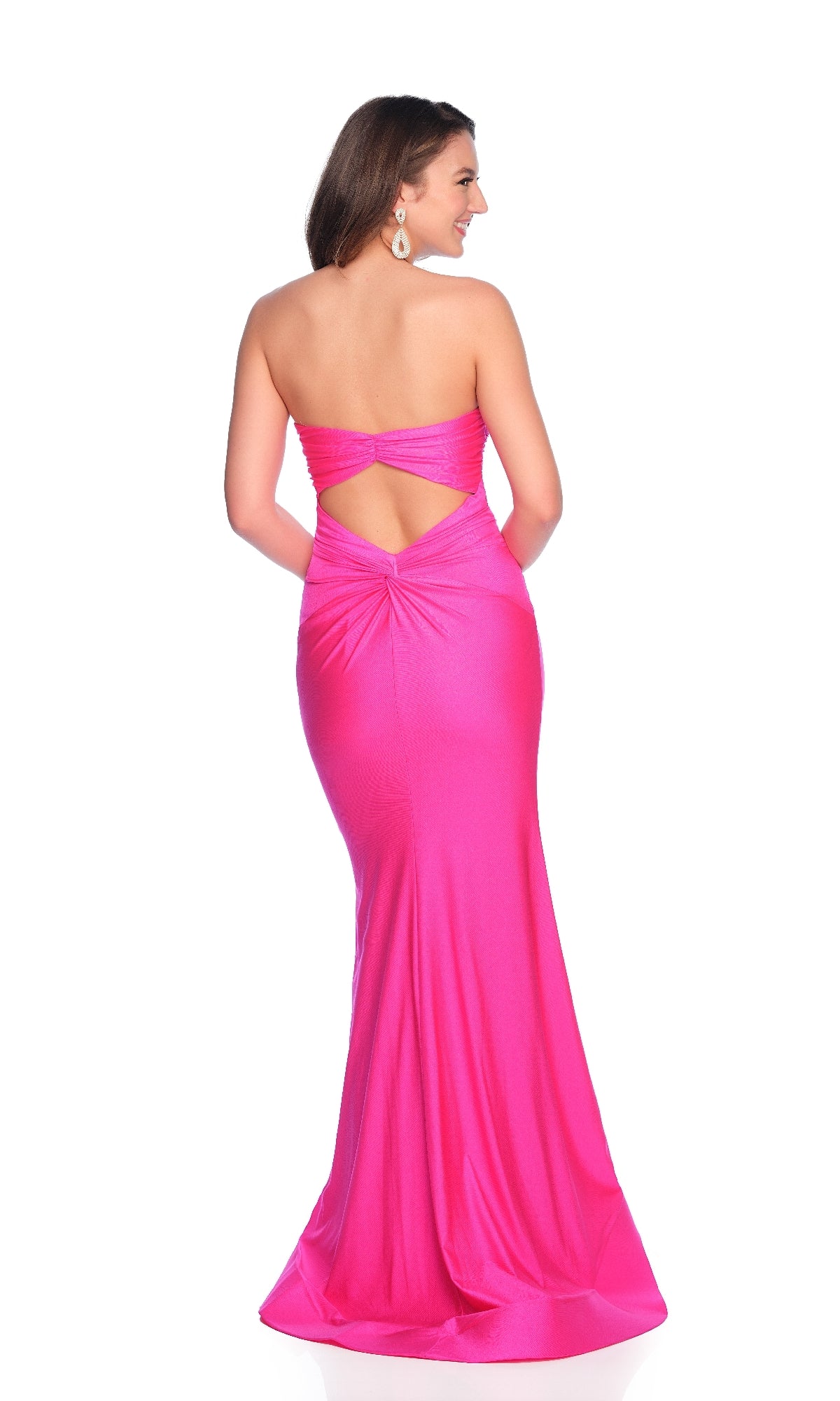 A woman models the Dave and Johnny 12151 long prom dress—a strapless, floor-length bright pink gown with a sweetheart neckline, back cutout, and gathered detail—posing against a white background.
